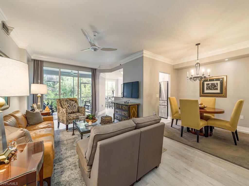 a living room with furniture ceiling fan and a window