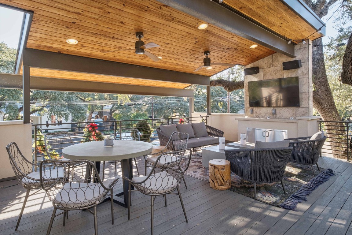 a view of a patio with table and chairs and floor to ceiling window