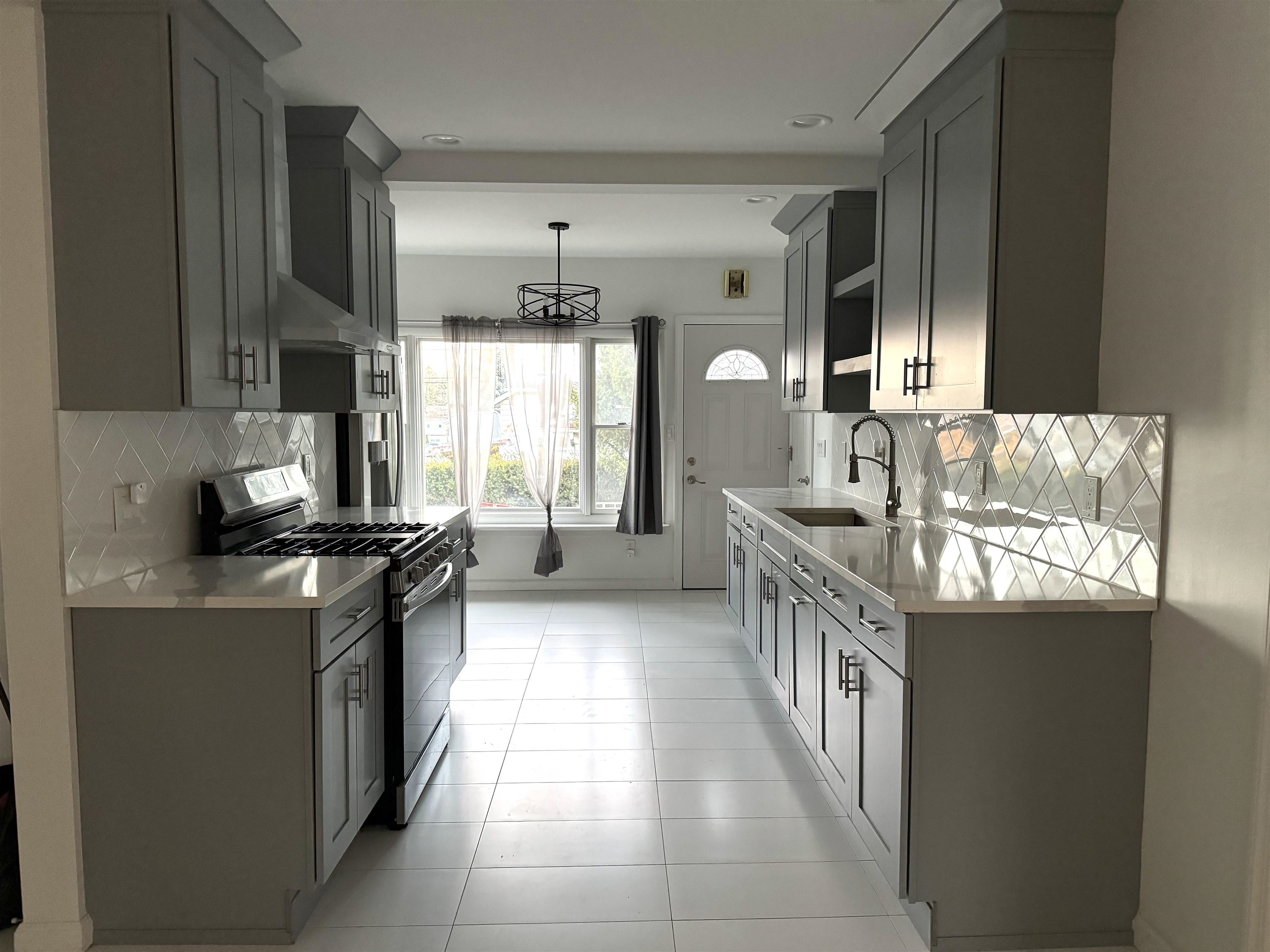 a kitchen with granite countertop a stove and a sink