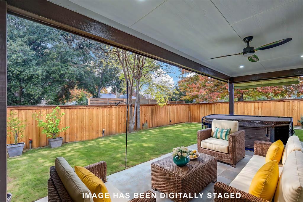 a view of a porch with furniture and a yard