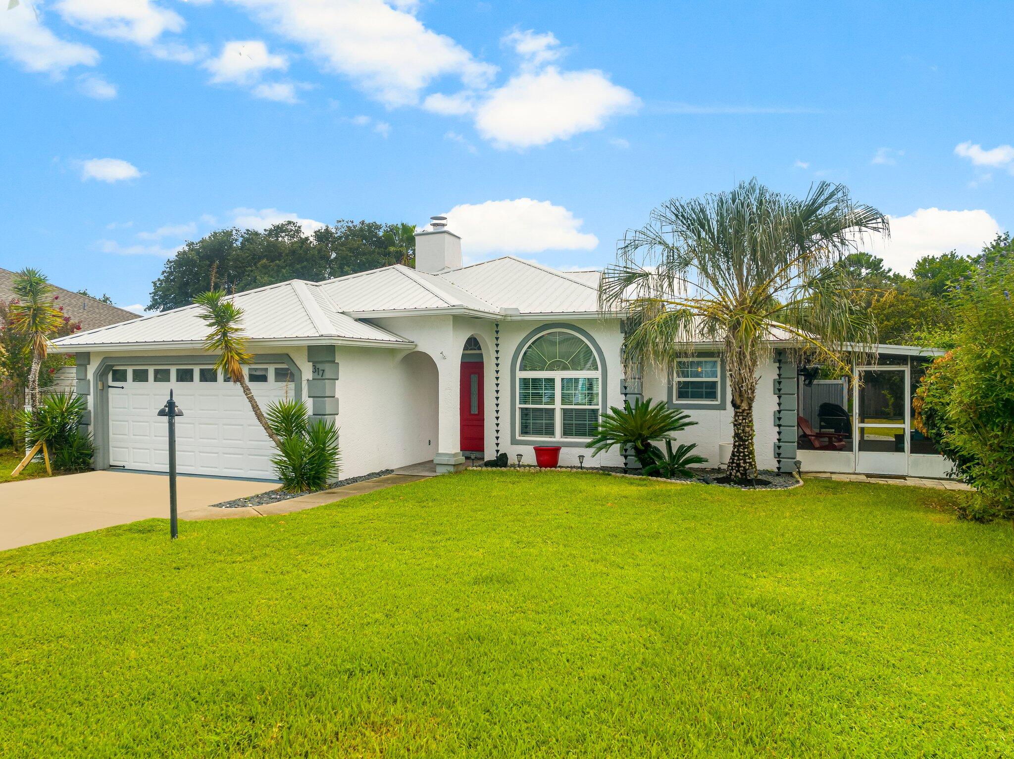 a view of a house with a yard and garage