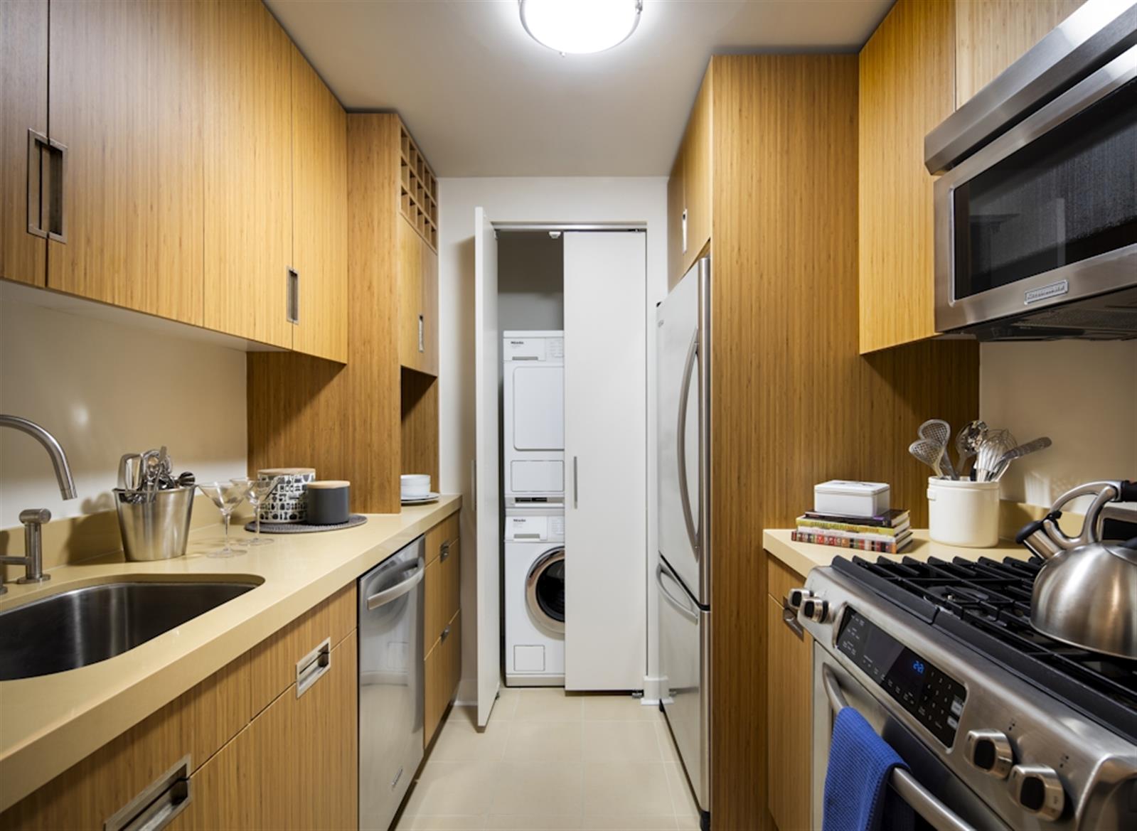 a kitchen with stainless steel appliances granite countertop a sink a stove and a refrigerator