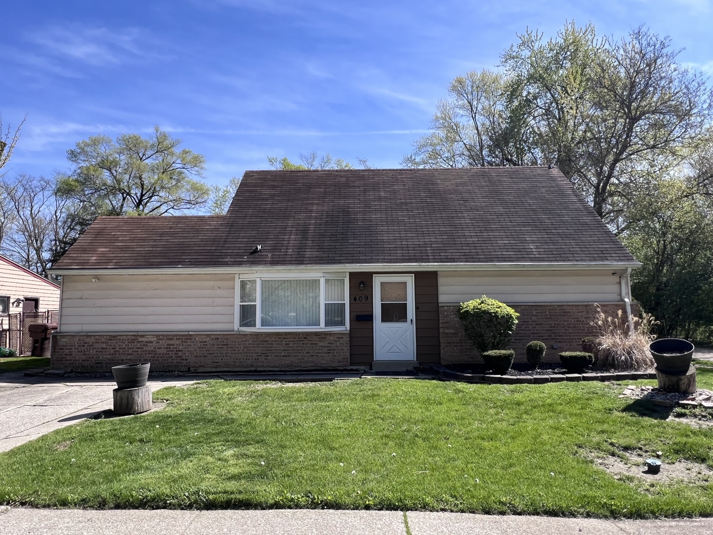 a front view of a house with a garden