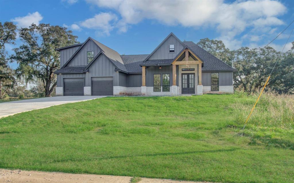 a front view of house with yard and green space