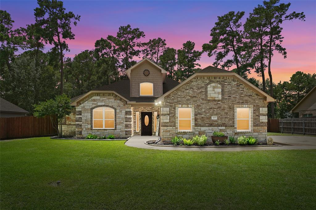 a front view of a house with a garden