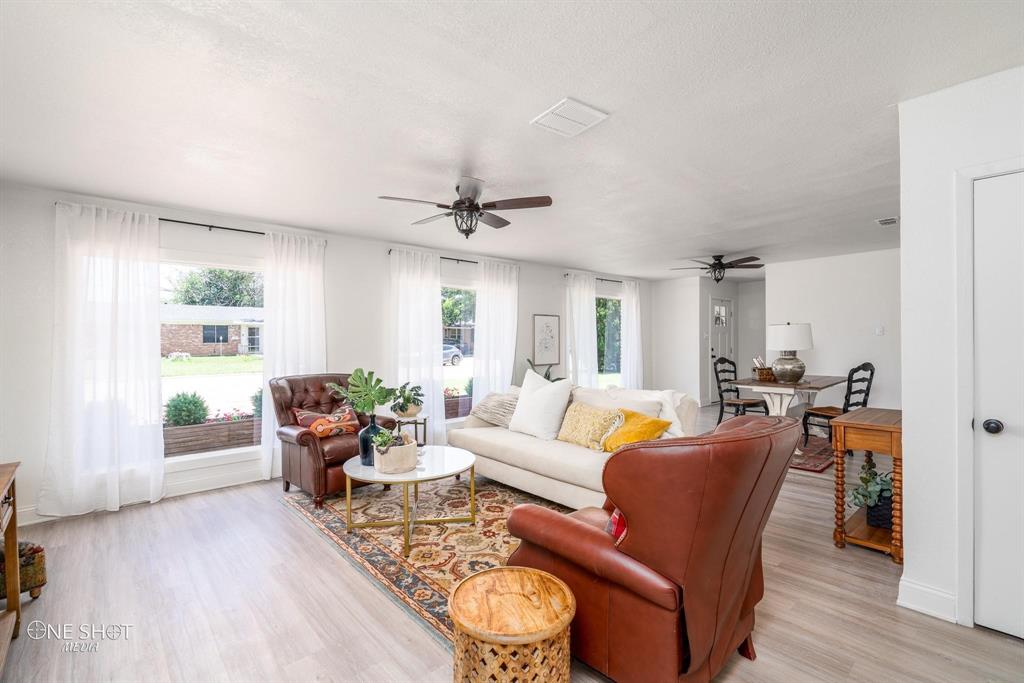 a living room with furniture and wooden floor