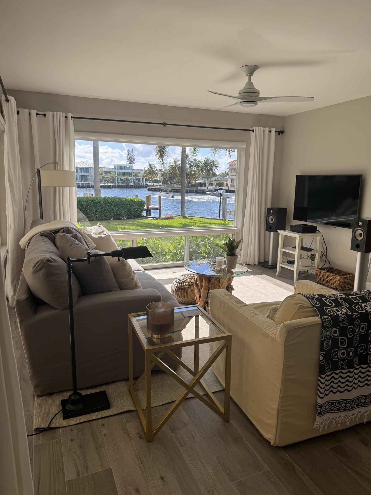 a living room with furniture and a floor to ceiling window