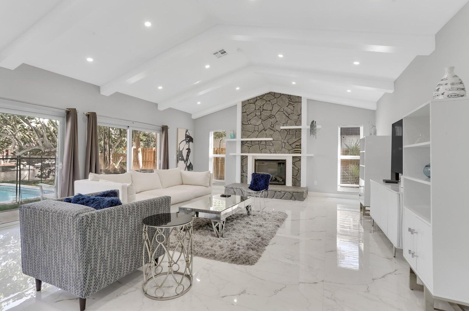 a living room with furniture wooden floor and a fireplace