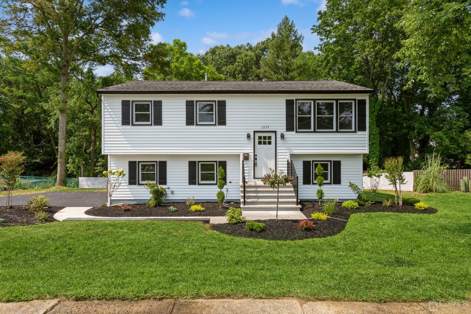 a front view of house with yard and outdoor seating