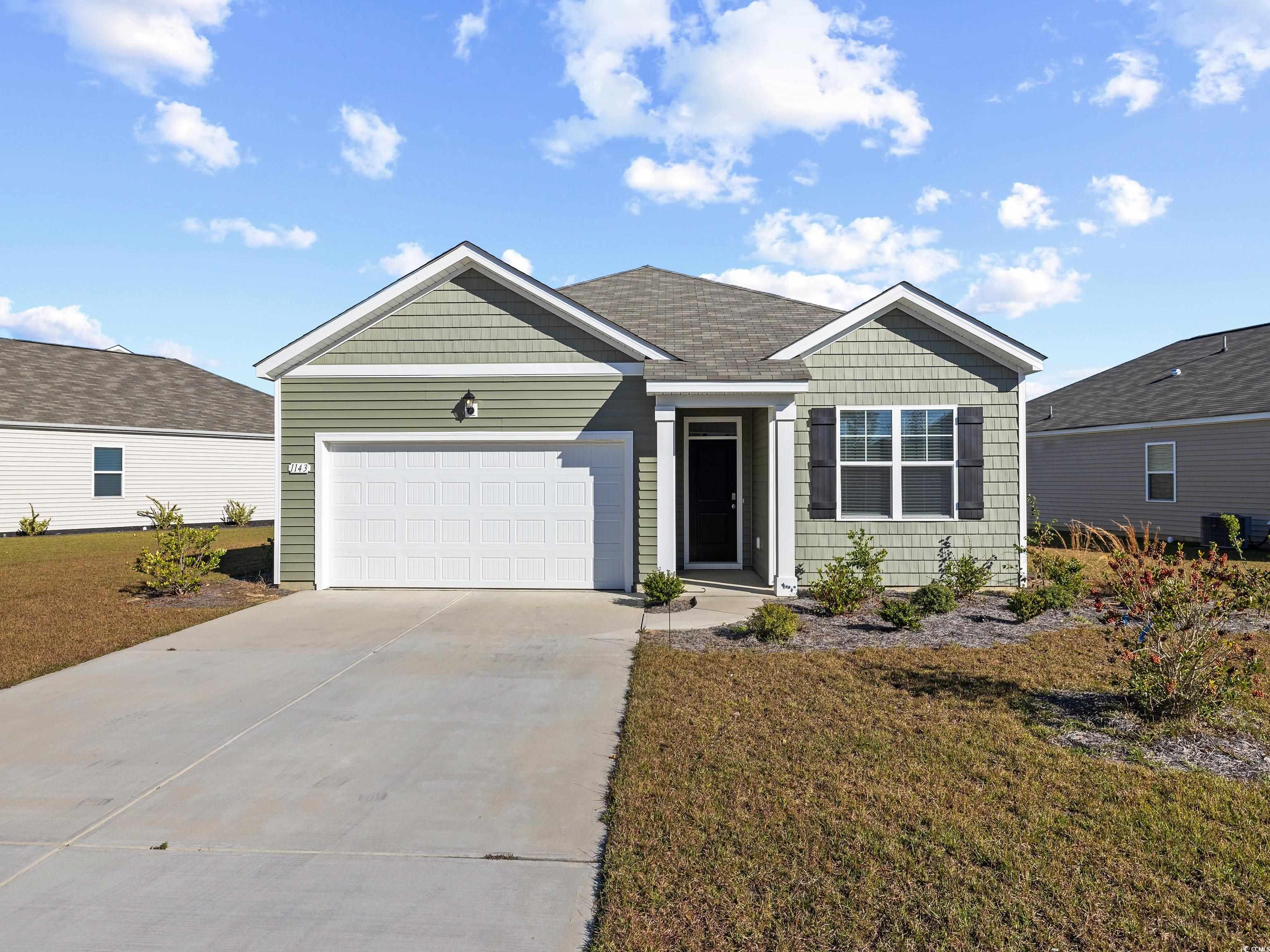 View of front of house with a garage and a front l