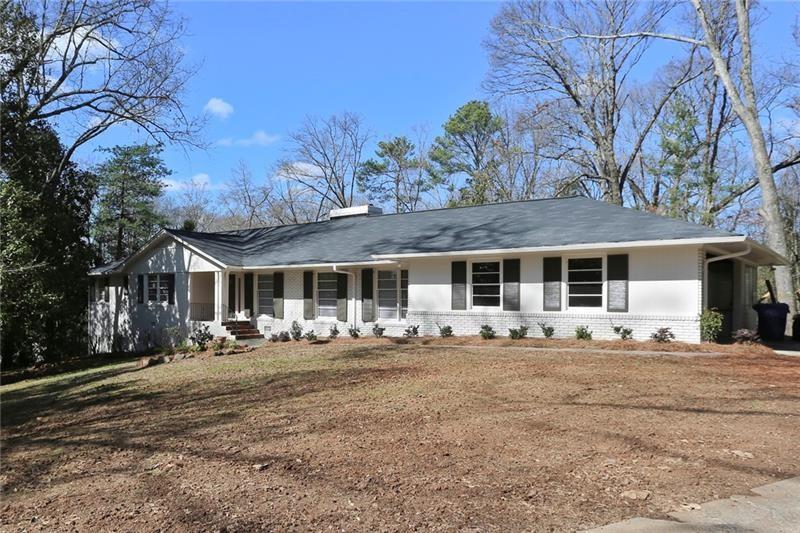 a front view of house with yard space and seating area