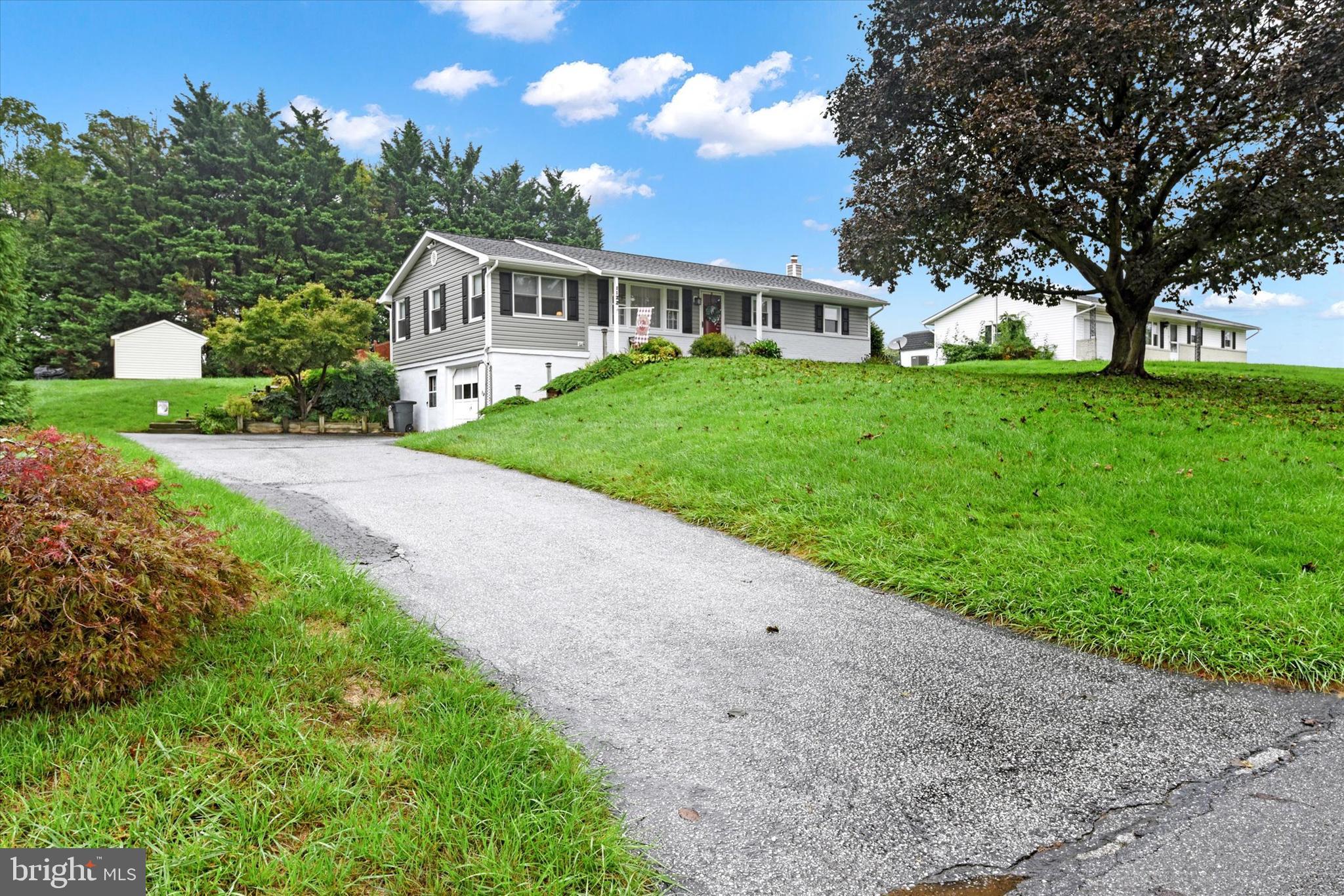 a front view of house with yard and green space