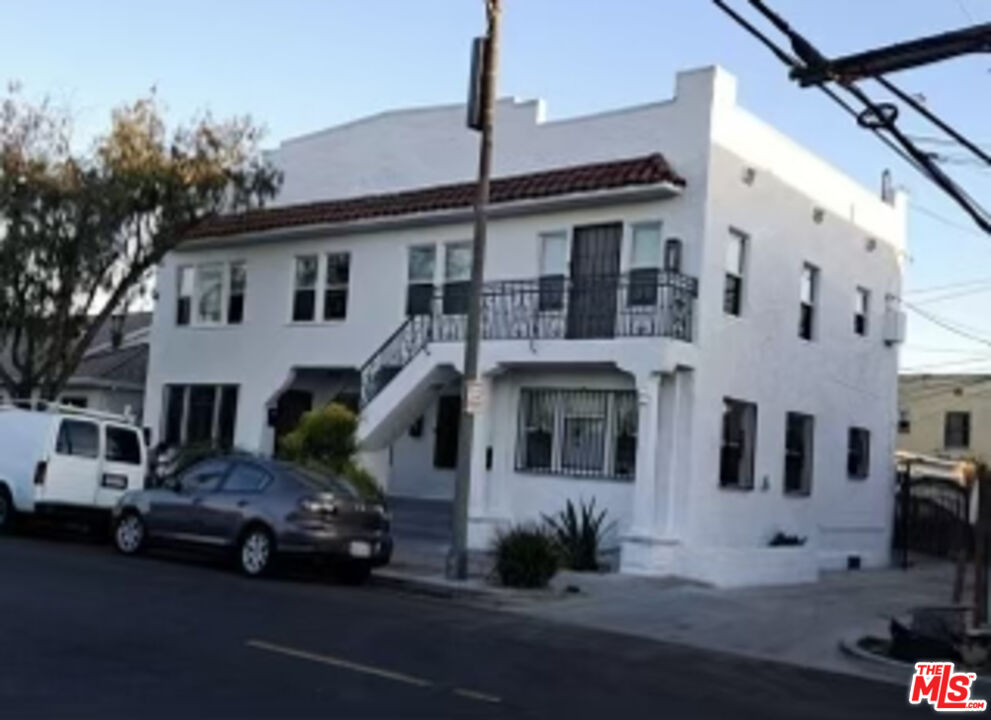 a car parked in front of a white building