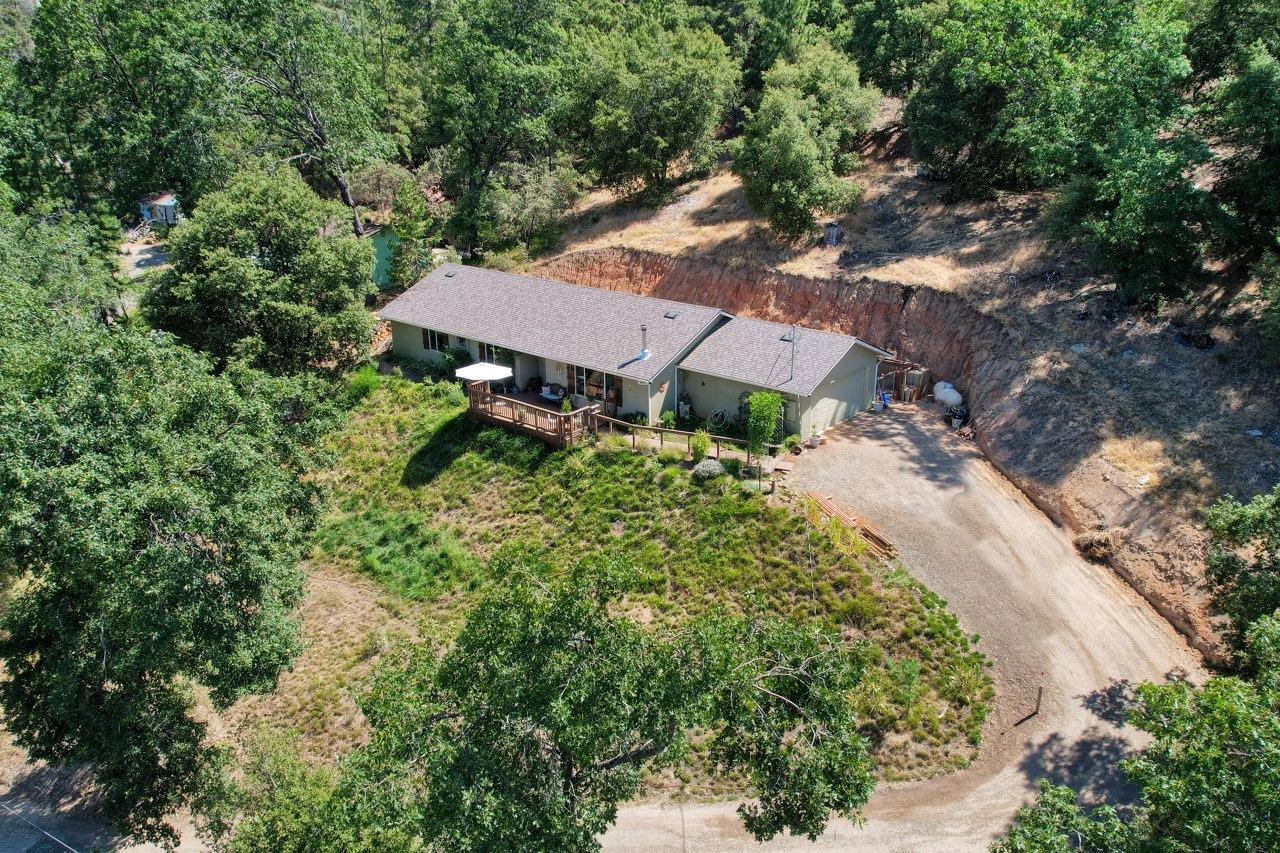 an aerial view of a house with a yard