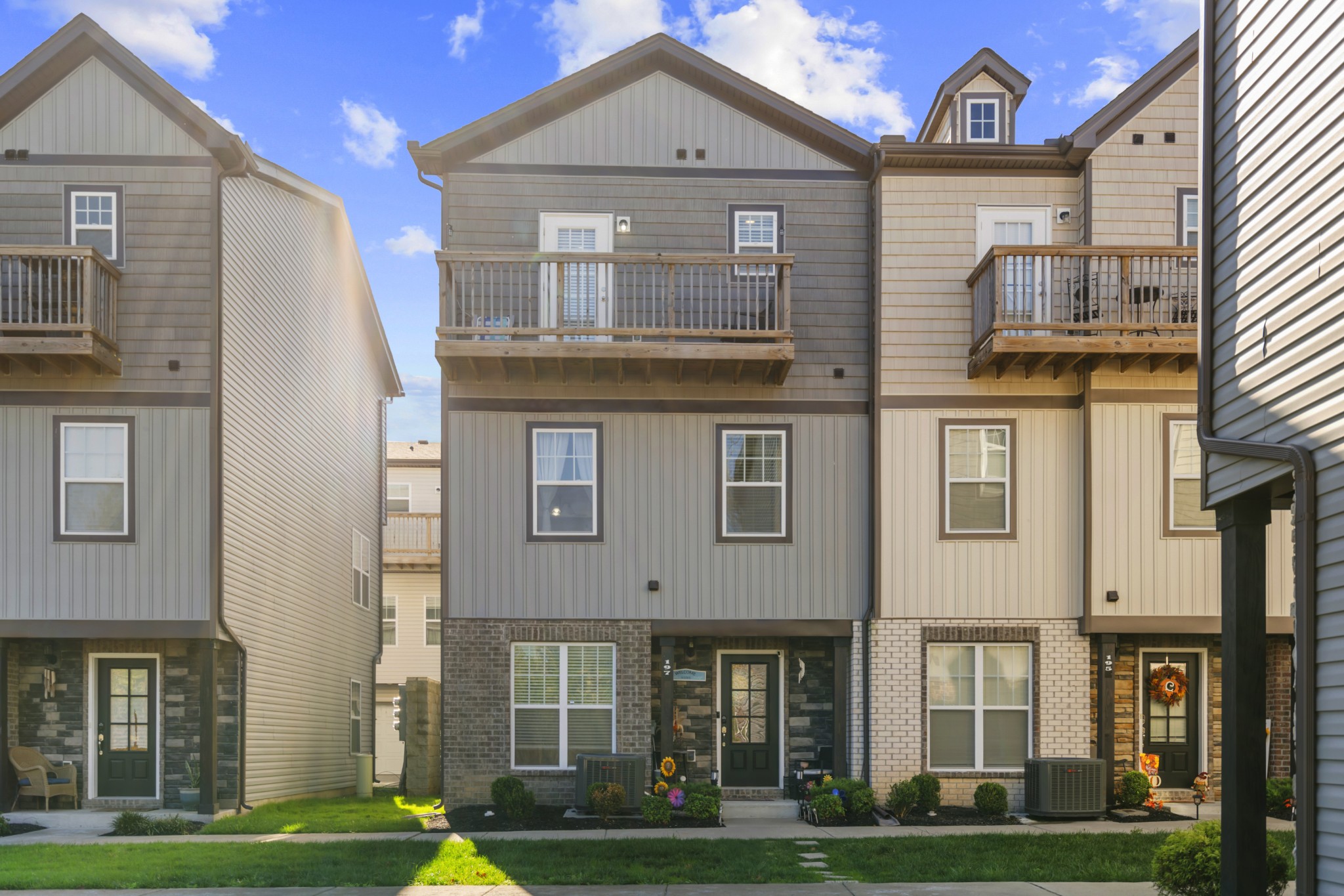 a front view of a residential apartment building with a yard