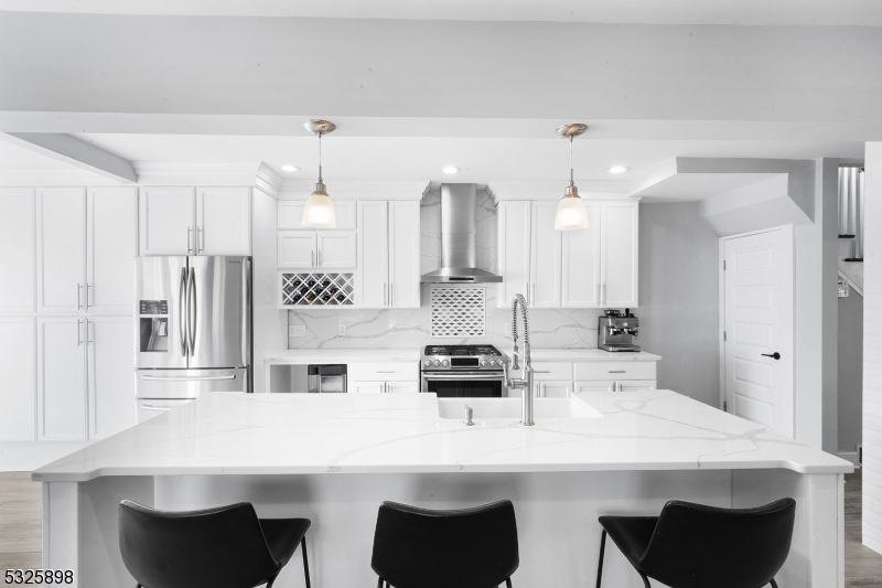 a kitchen with stainless steel appliances kitchen island granite countertop a sink and cabinets