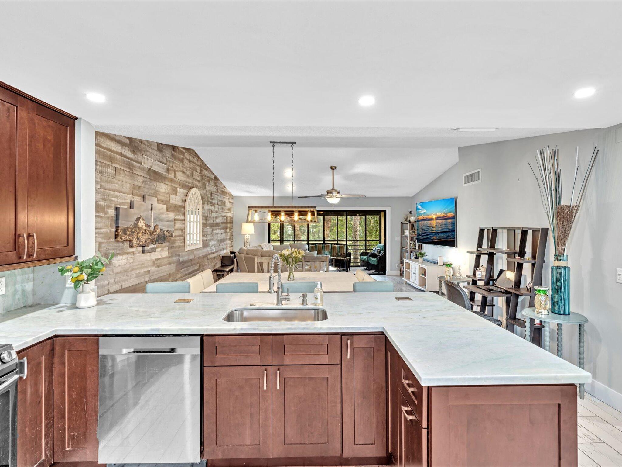 a kitchen with stainless steel appliances granite countertop a sink stove and refrigerator