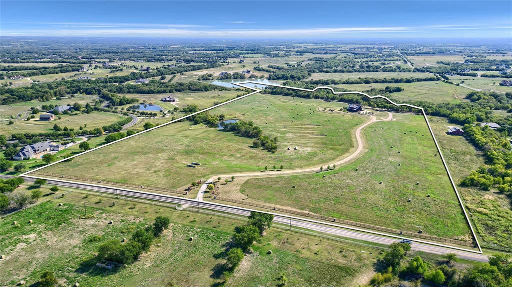 an aerial view of a residential houses with outdoor space