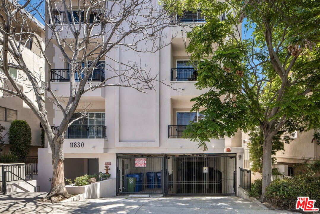 a front view of a building with trees