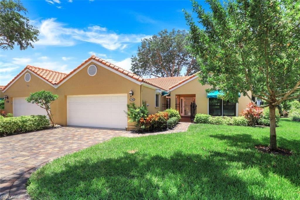 View of front of house with a front lawn and a garage