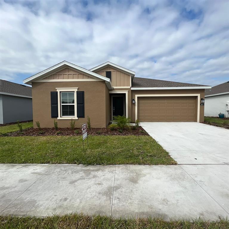 a front view of house with garage and yard