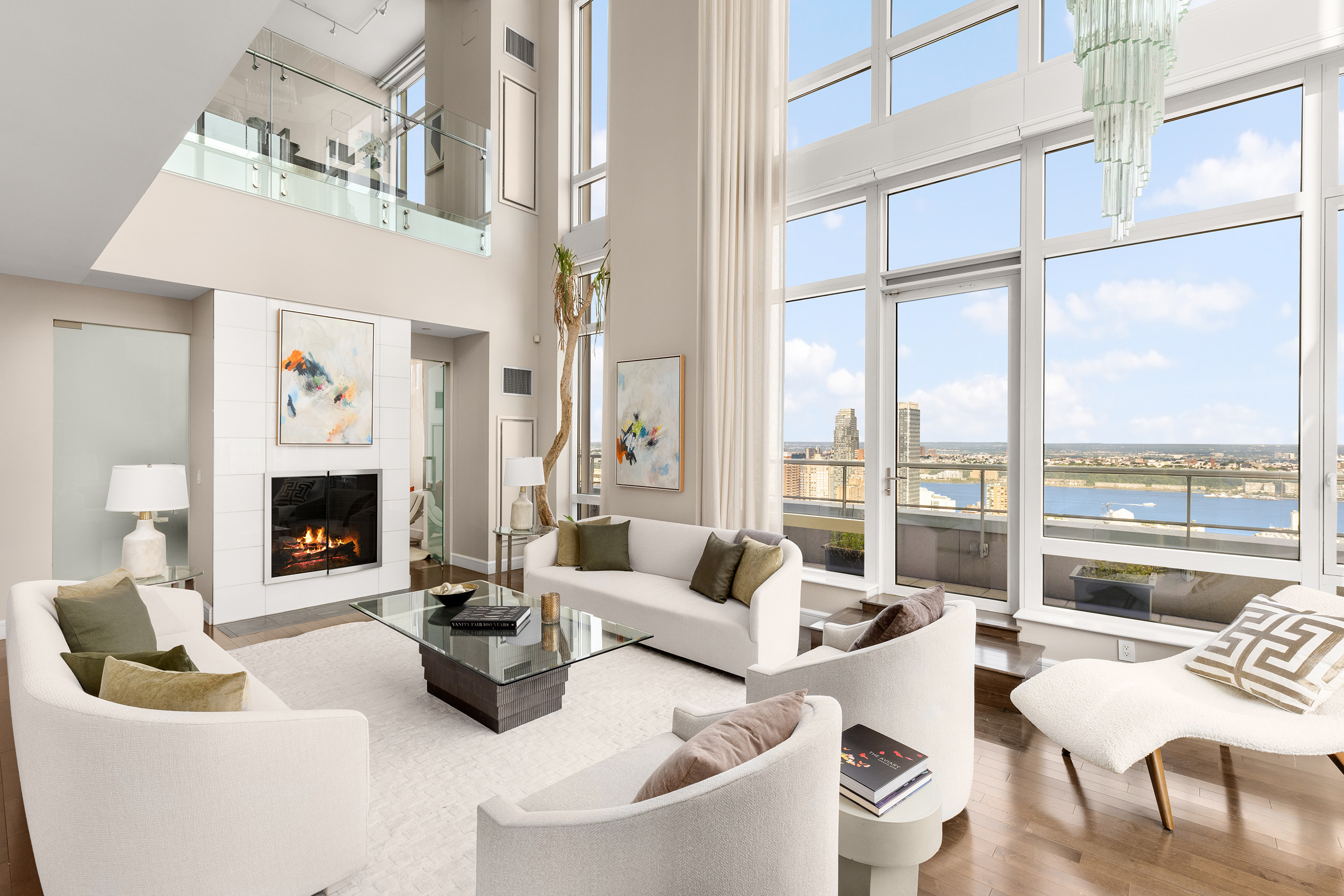 a living room with furniture a fireplace and a floor to ceiling window