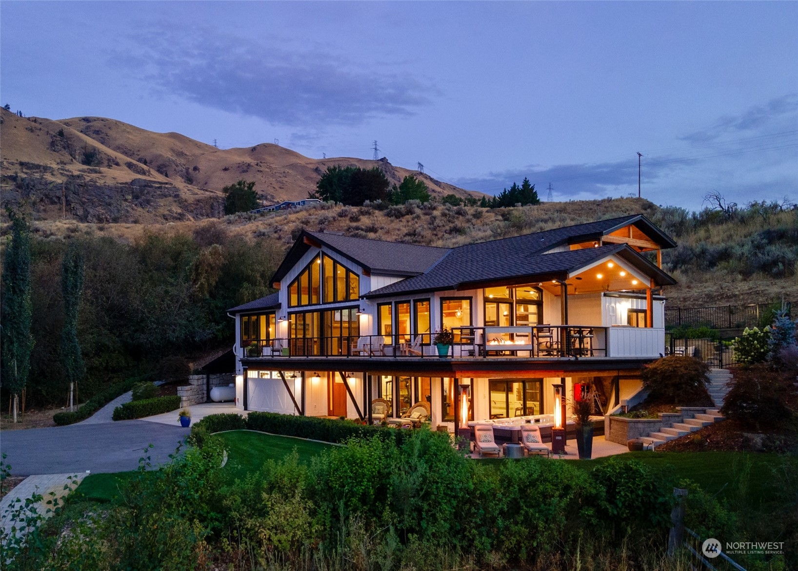 a front view of a house with a yard and lake view