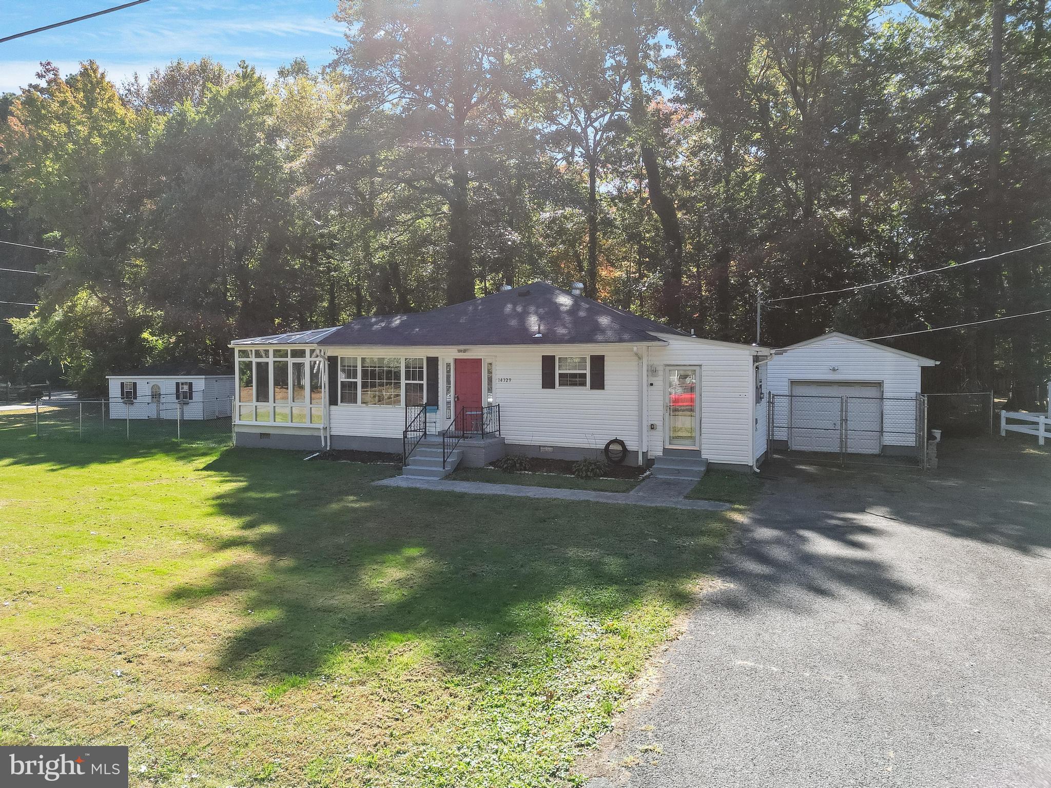 a front view of house with yard swimming pool and outdoor seating