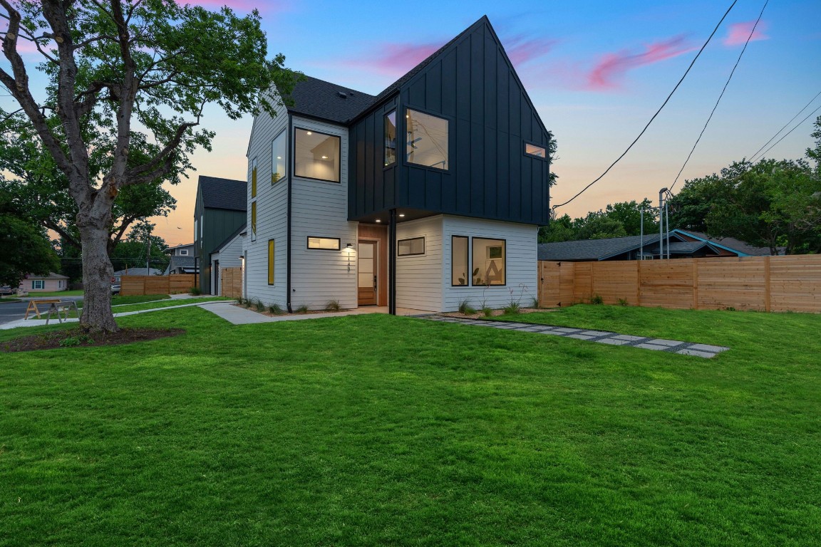 a front view of house with yard and green space