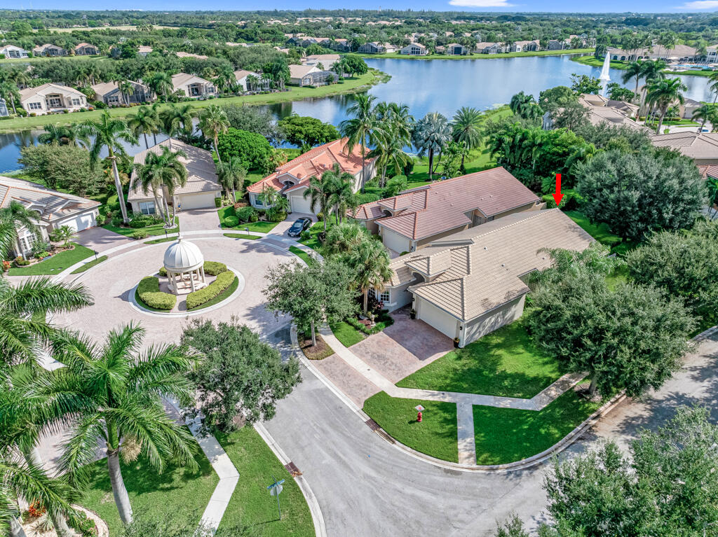 an aerial view of a house with outdoor space and lake view