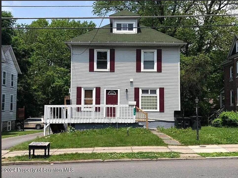 a front view of a house with a yard table and chairs