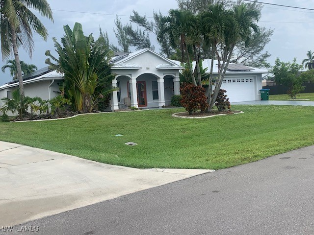 a front view of a house with a garden and plants