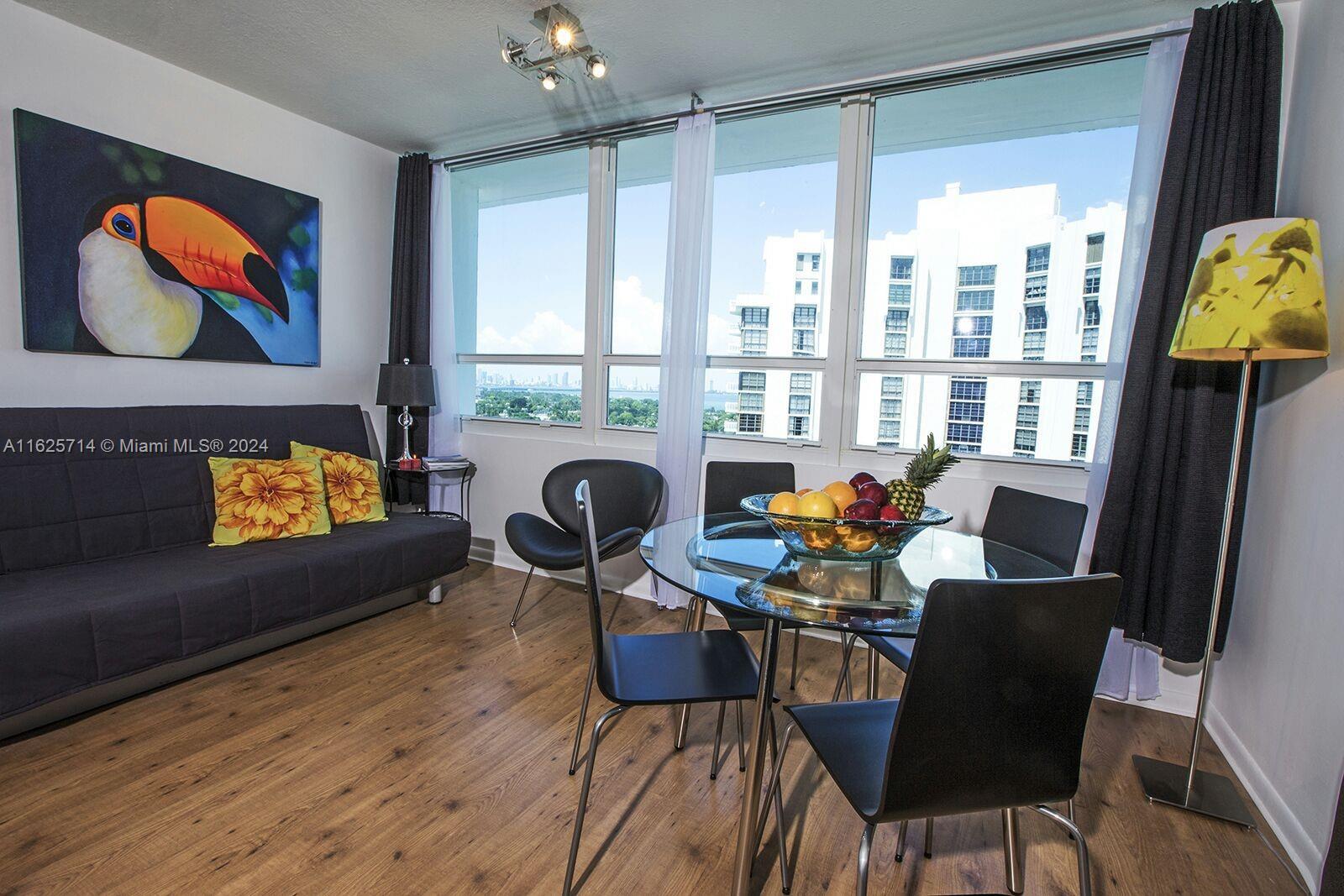 a living room with furniture and a floor to ceiling window