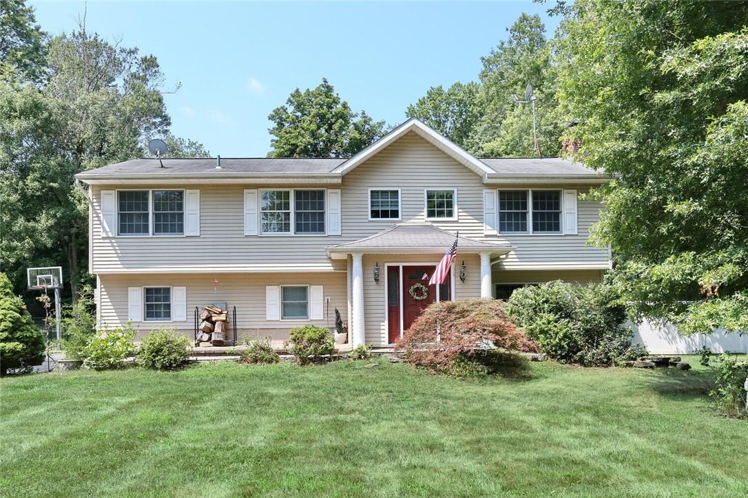 a front view of house with yard and green space