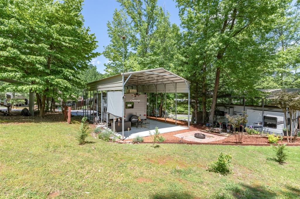 a view of a house with backyard and sitting area