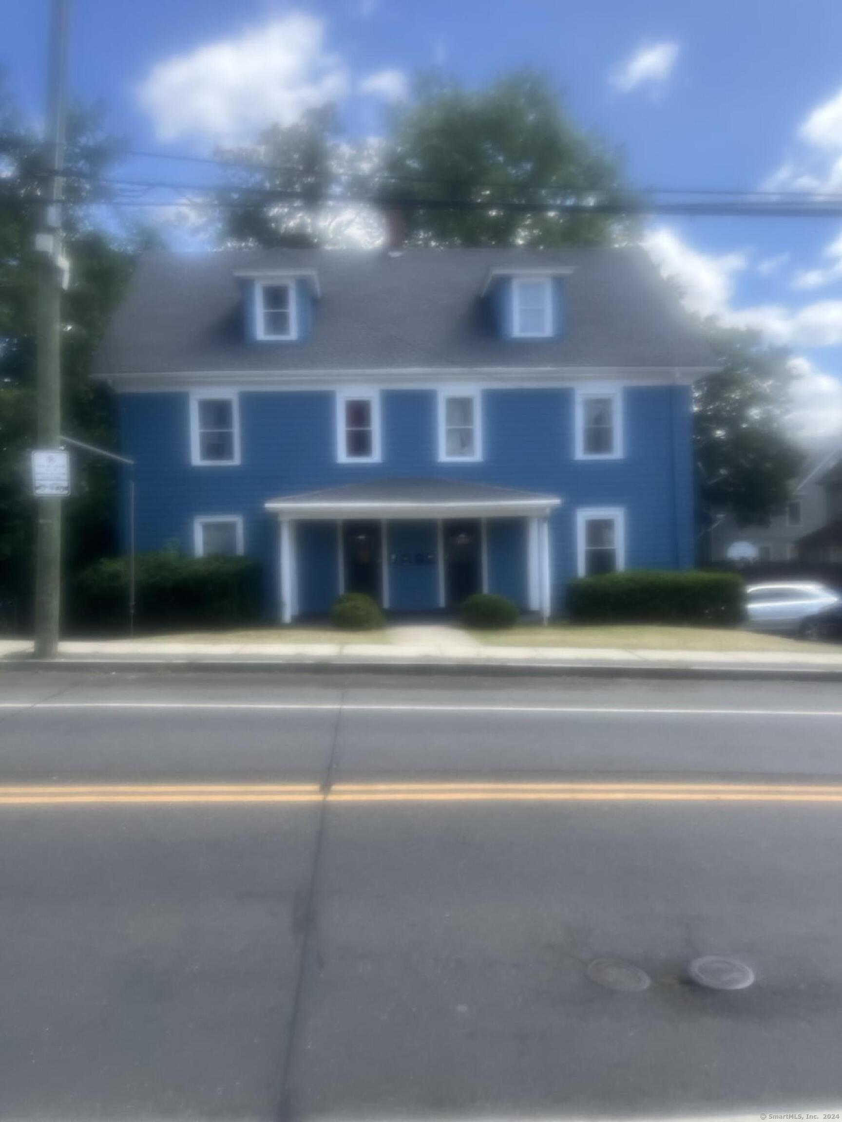 a view of building with a yard in the background