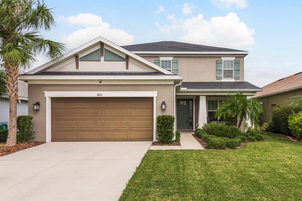 a front view of a house with a yard and garage