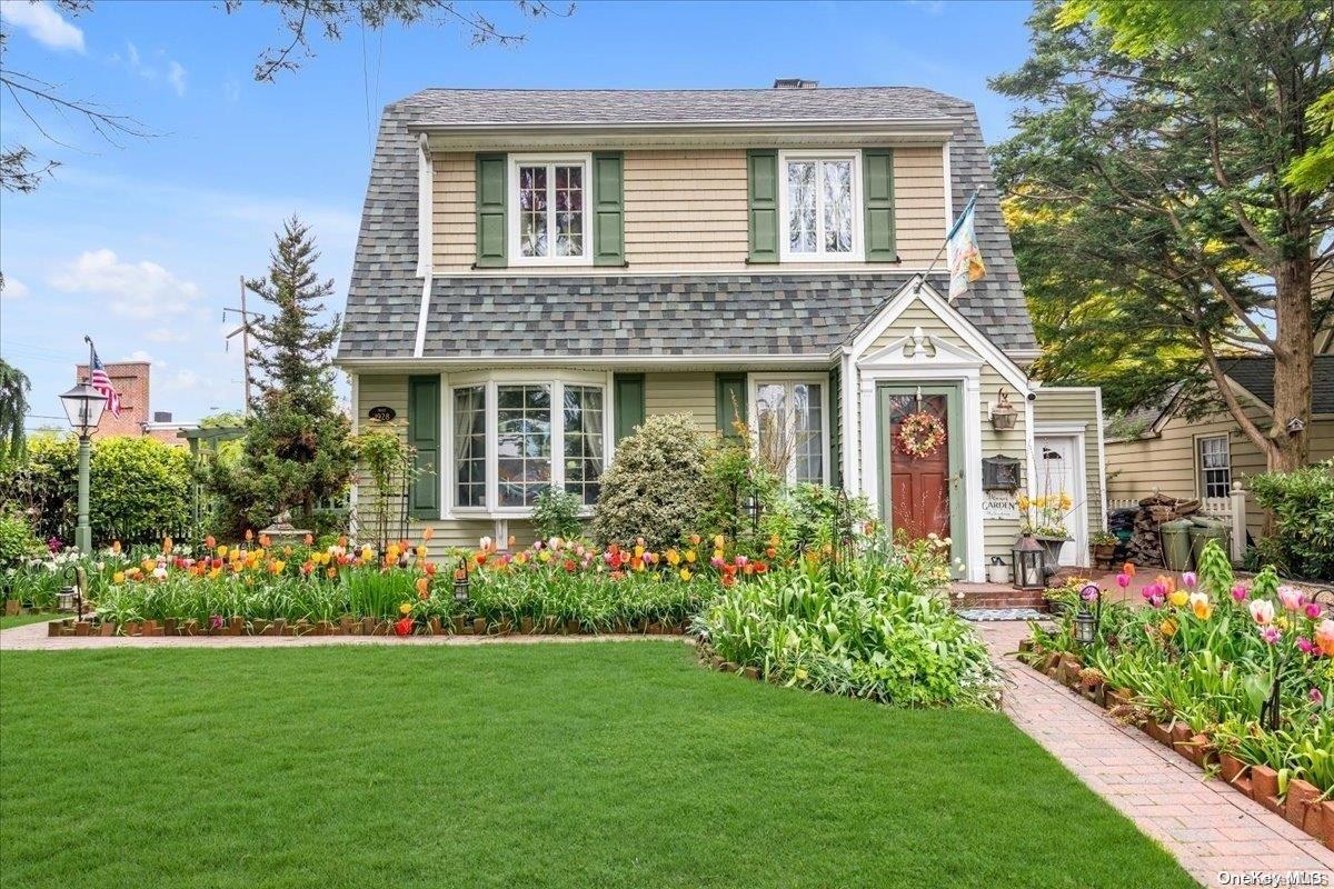 a front view of a house with a garden