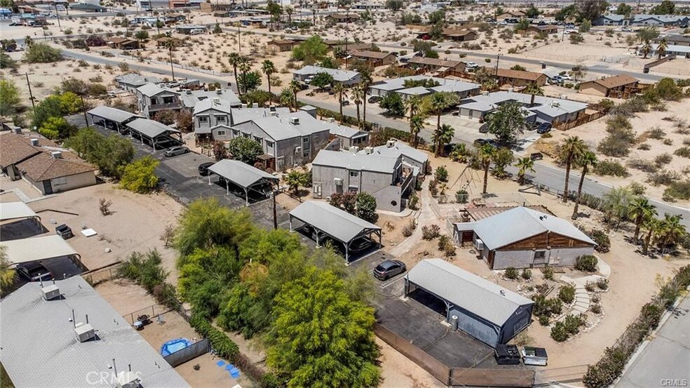 an aerial view of multiple houses with yard