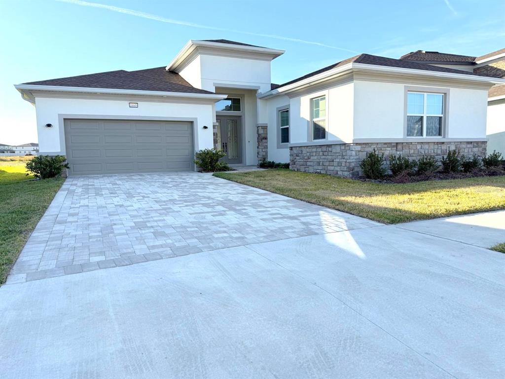 a front view of a house with a yard and garage