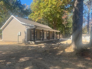 a view of a house with a tree in front of it