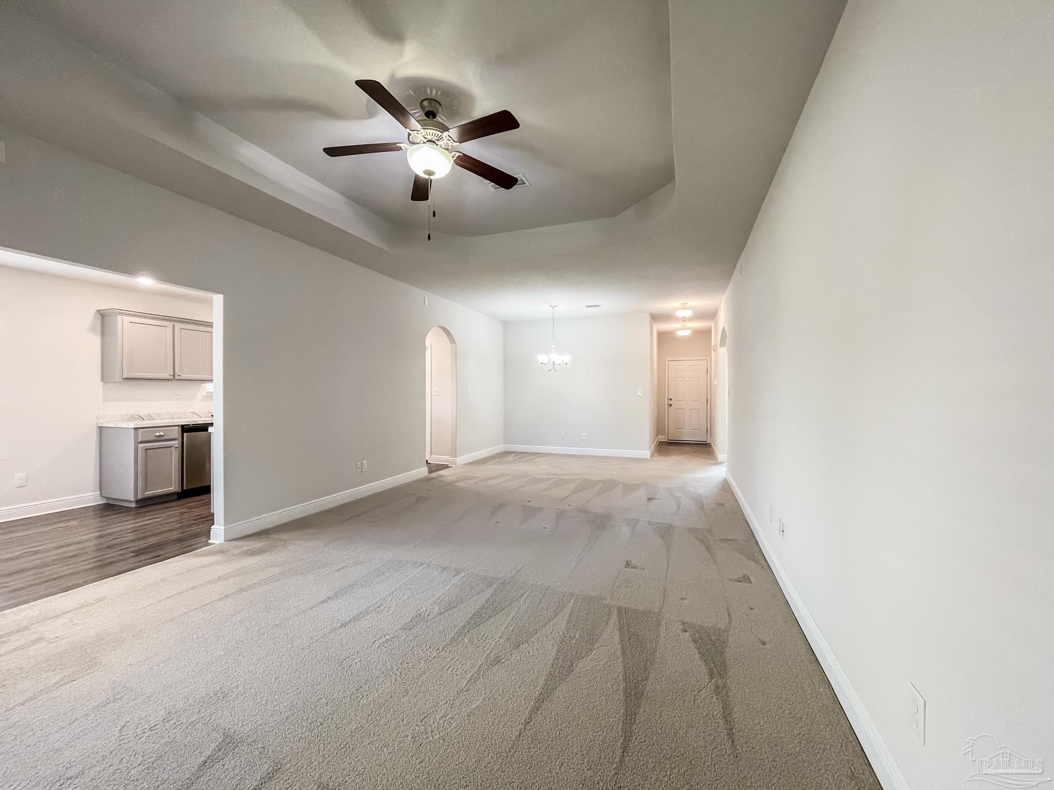 a view of a livingroom with a ceiling fan and window