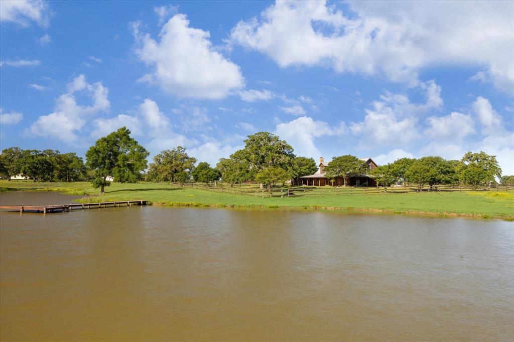 a view of a lake with houses in the back