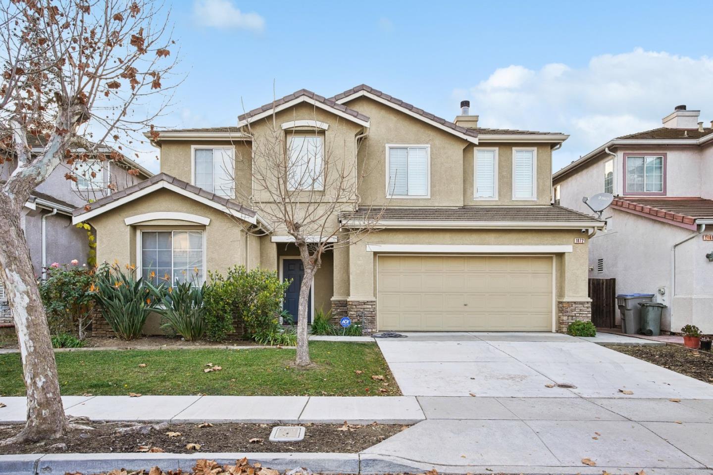 a front view of a house with a yard and garage