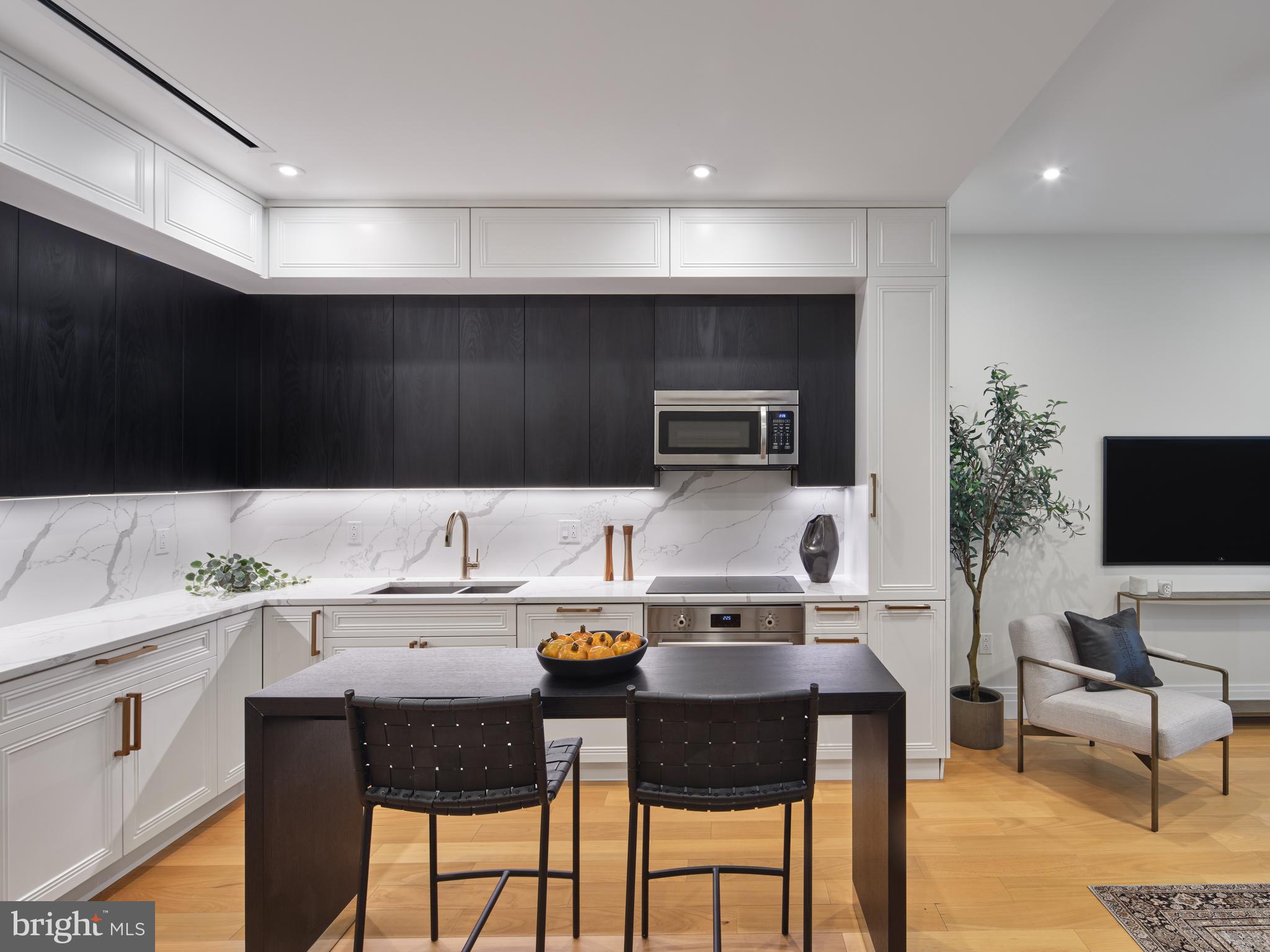 a kitchen with a sink and chairs