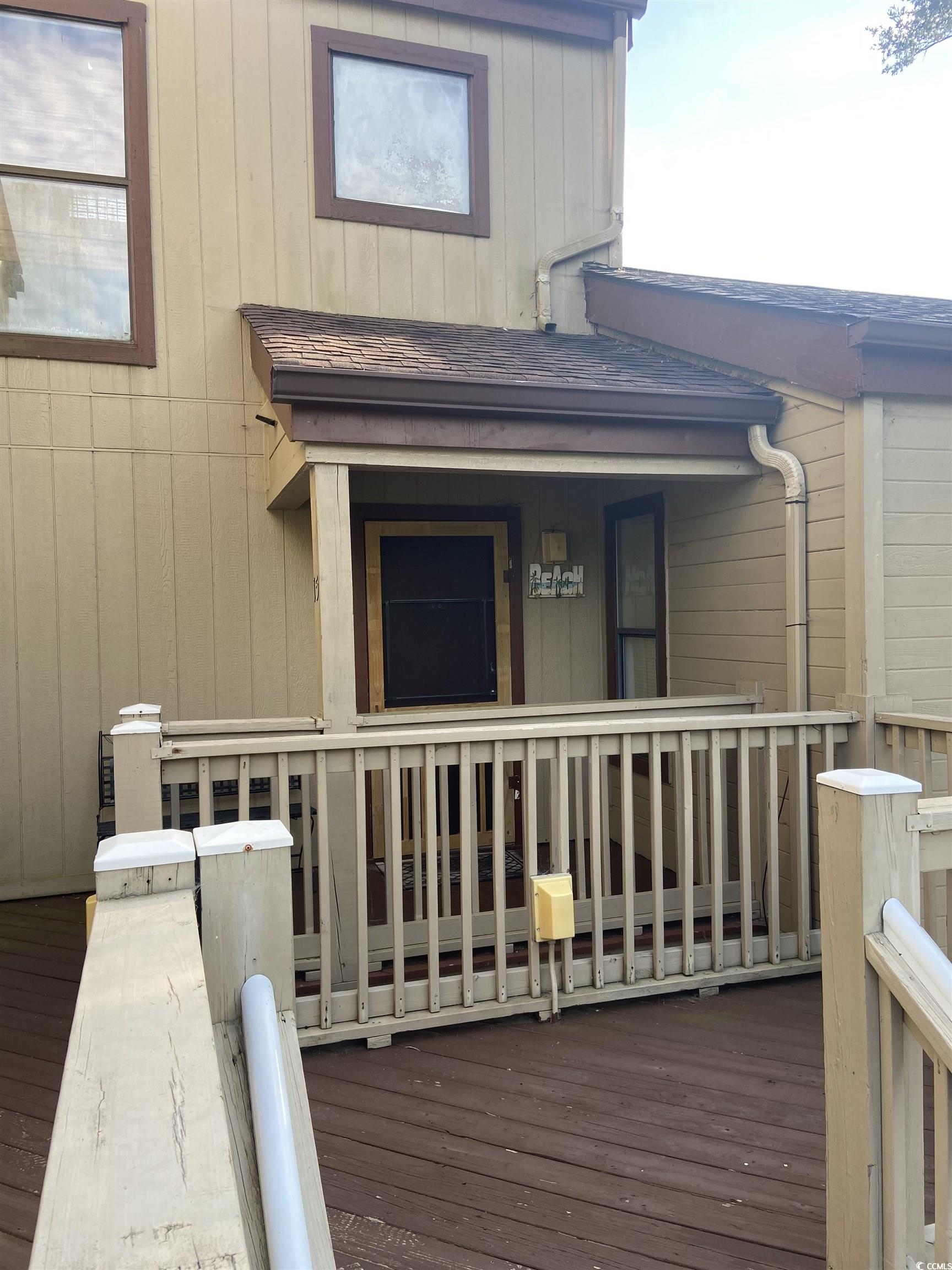 Entrance to property featuring a deck