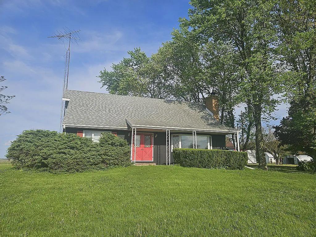 a front view of house with yard and trees