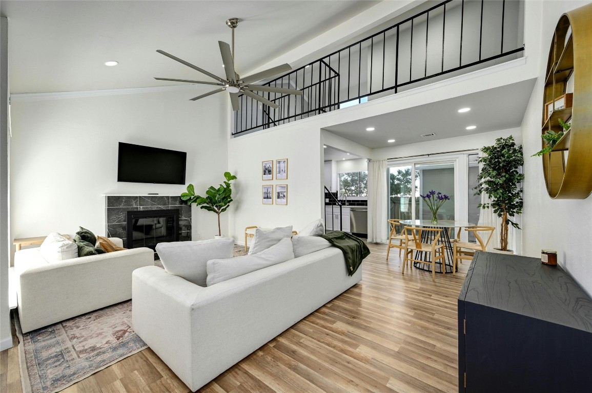 a living room with furniture a fireplace and a flat screen tv