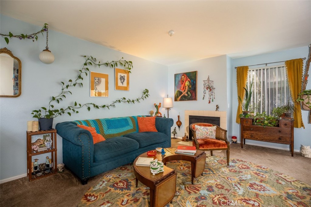 a living room with furniture and paintings on the wall