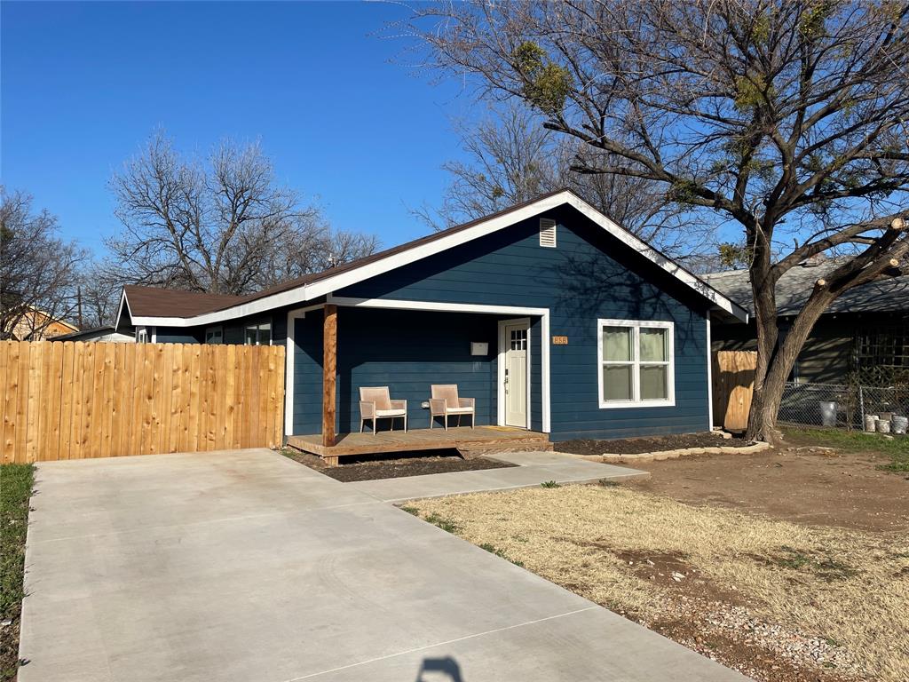 a front view of a house with a yard outdoor seating and garage